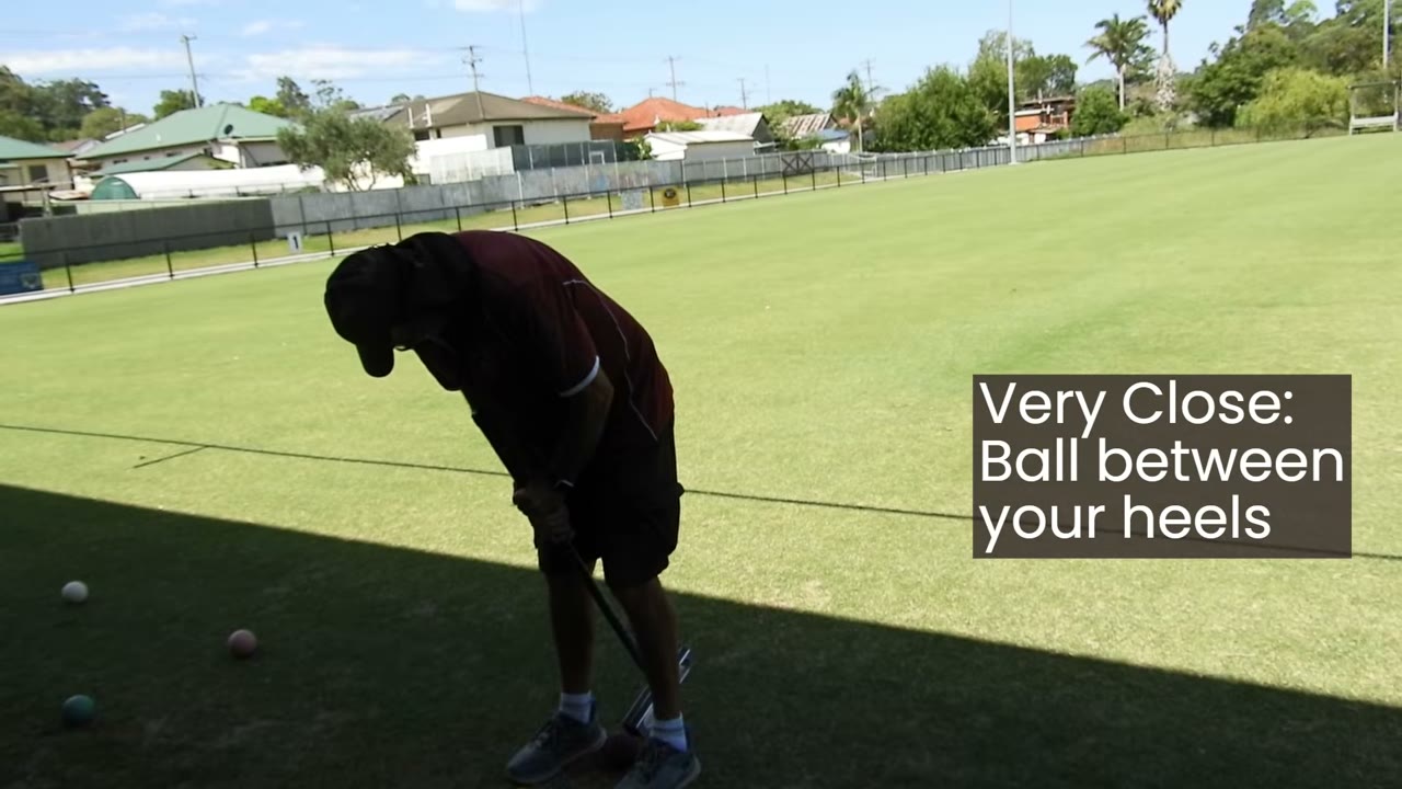 Player bent low over a ball positioned almost between their heels, caption: 'Very Close: Ball between your heels.'